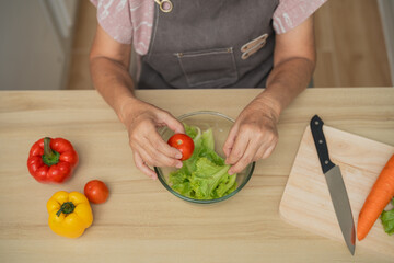 Fresh Salad Preparation with Colorful Vegetables and Ingredients in a Cozy Kitchen Environment Emphasizing Healthy Eating and Cooking Practices