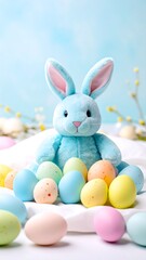 Obraz premium A light blue plush Easter bunny sits amidst a collection of pastel-colored speckled eggs on a white cloth.