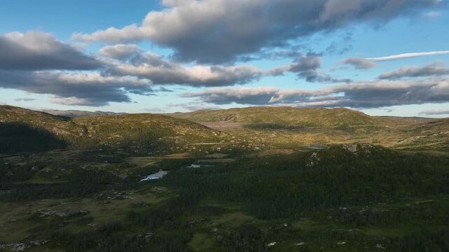 Drone moves forward towards Sysenvatnet dam, rising to reveal reservoir for power supply
