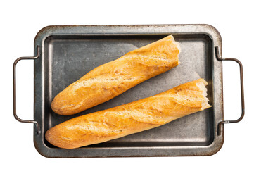French broken bread baguette in steel tray isolated on white background. top view