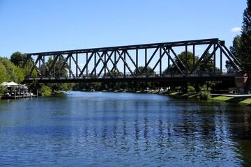 Fototapeta premium Scenic landscape panorama of the historic railway bridge across river Havel in Caputh, Brandenburg, Germany