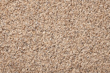 Fototapeta premium Close-up of granular, beige and brown substance with varying textures. Natural, slightly uneven surface filling the frame