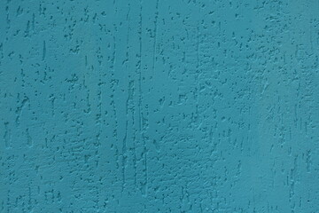 Background - turquoise blue wall with stucco worm finish
