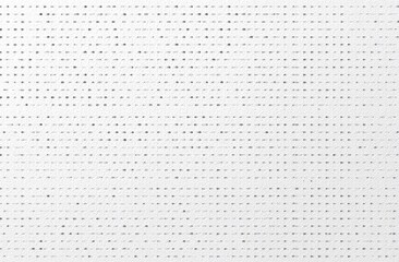 Abstract pattern of numerous tiny dark gray dots on a white background, arranged in parallel rows