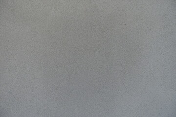 Surface of grey wall with grained roughcast render