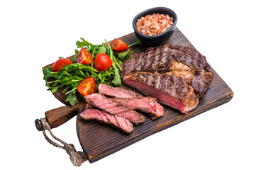 Rib eye steak with herbs on wooden board with salad, grilled prime beef meat isolated on white background