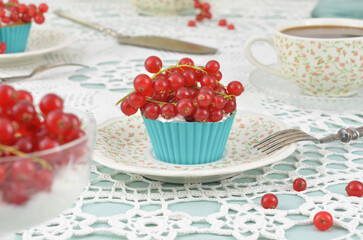 Fruit cupcakes and dessert with cream on the table, decoration for example for a wedding, anniversary, engagement, name day, Mother's Day or Grandma's Day. Retro napkins, blue and red decorations. 