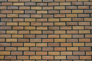 Surface of brick veneer wall with stretcher bond pattern in shades of brown