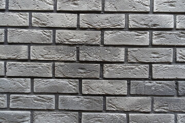 Surface of brick veneer wall with stretcher bond pattern in shades of gray
