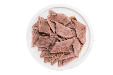 Corned Boiled and sliced beef meat with spices and herbs on a plate isolated on white background