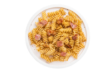 Fusilli carbonara pasta topped with crispy bacon bits and parmesan  cheese  in a plate isolated on white background