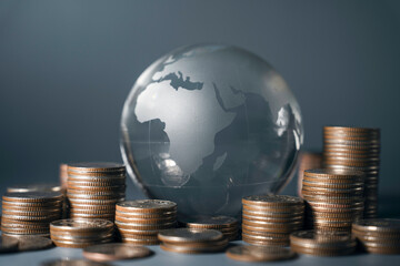 Global finance system concept. Crystal Globe on stack coins, Economy financial banking, money exchange transfer international, inflation and tax, interest rate, business, finance and investment
