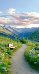 Serene path through a mountain meadow leads to distant peaks under a vibrant sky