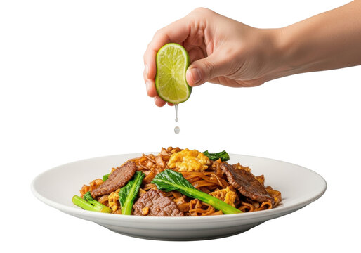 Adult hand squeezing vibrant lime wedge, juice drop falling onto Pad See Ew noodles with beef and gai lan on white plate, transparent background, dynamic fresh food concept