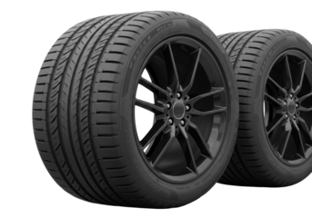 Isolated performance car tires mounted on custom black rims studio automotive product shoot