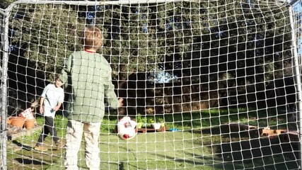 Young goalkeeper protecting soccer goal during penalty kicks - Powered by Adobe
