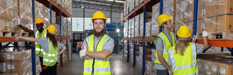Group of warehouse workers in safety gear organizing inventory on shelves with teamwork and focus. Industrial logistics and warehouse operation concept for supply chain visuals.