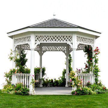 White gazebo with ornate detailing, surrounded by flowering plants and greenery on a grassy lawn