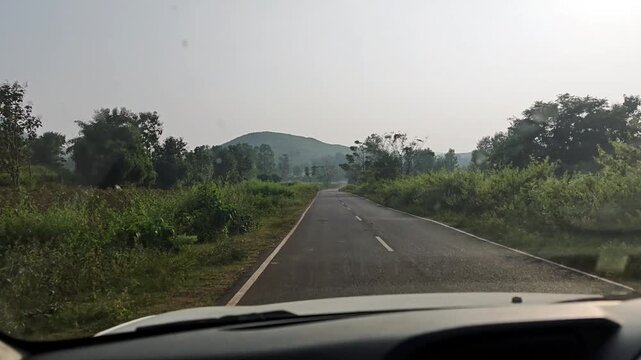Road trip by car in the forest covered foothills of Koraput, Odisha, India in November 2024