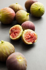 Fresh figs placed on dark table.