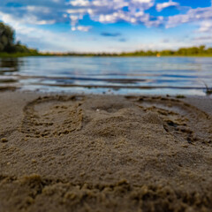 footprints in the sand. water and prints in the sand. woman legs or baby boy,kid,child barefoot feet on sand beach.girl is relaxing against sea or ocean.water waves washing steps, or heart shape.