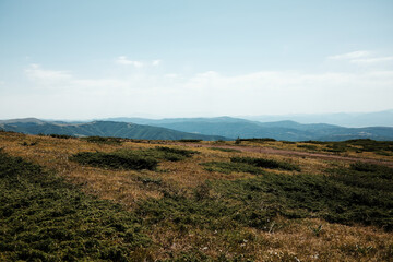 Expansive mountain view from Stara Planina, Serbia, with rolling hills and grassy plateaus stretching into the horizon