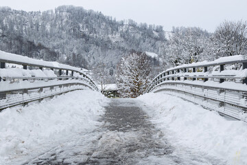 Symmetrical snowy bridge in a quiet winter landscape