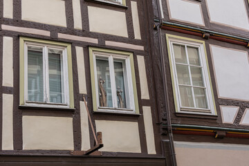 Close view of half timbered house with decorative wooden cat figures in Hann Münden