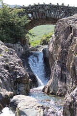 Stone bridge over a waterfall in the Lake District