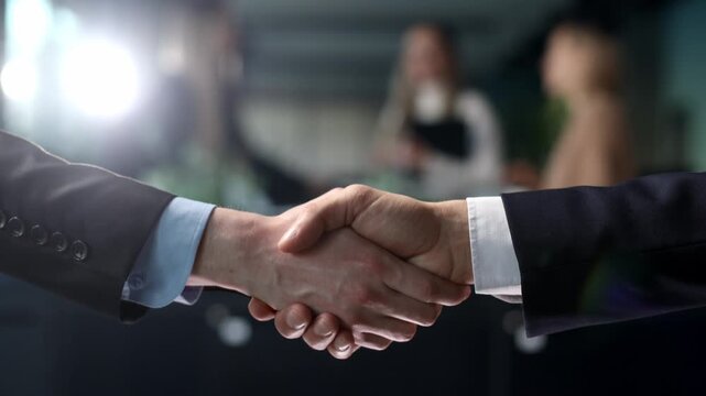 Two men shaking hands in a business setting
