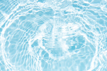 Blue water with ripples on the surface. Defocus blurred transparent blue colored clear calm water surface texture with splashes and bubbles. Water waves with shining pattern texture background.