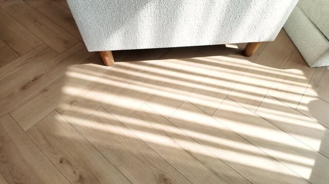 Natural wood laminate parquet floor. Room with floating laminate in new apartmen. Cozy home interior, modern design