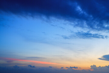 sunset in the sea. Beautiful colorful sky and cloud in twilight time background. Orange fluffy clouds and sun sunlight reflection in the blue sky.