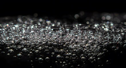 Shiny Silver Bubbles Forming on Dark Background in Macro