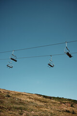 Panoramic view of Stara Planina mountains with chairlift and dry summer grassland stretching toward the horizon. Serbia country