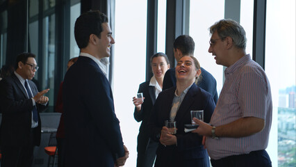 Business professionals networking and enjoying drinks at a corporate event