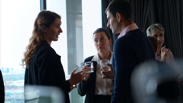 Business professionals networking and enjoying drinks at a corporate event