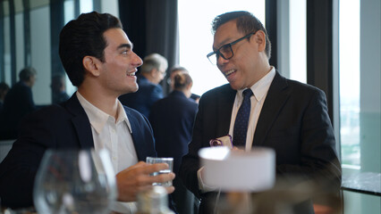 Business professionals networking and enjoying drinks at a corporate event