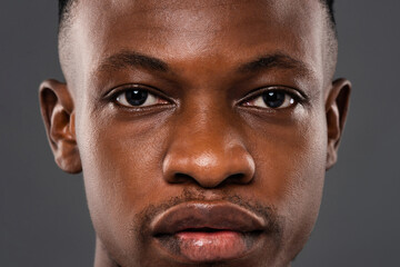 Close up portrait of African man face with eyes looking at camera showing strong expression and authentic detail