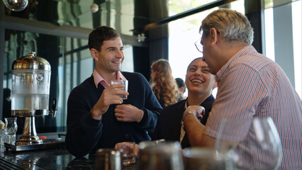 Smiling bartender serving drinks to customers at a modern bar