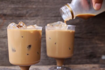 Pouring coffee with ice on glass