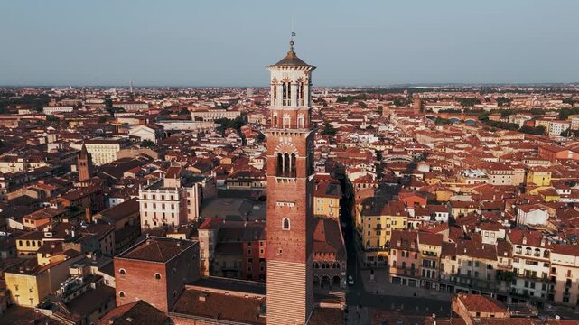 Circling Aerial Drone Shot of Torre dei Lamberti and Piazza Delle Erbe in Verona, Italy at Sunrise.
