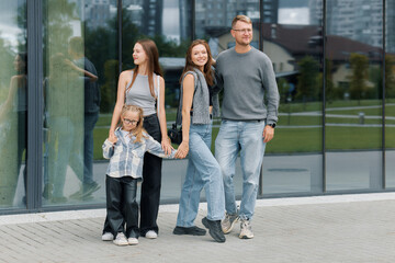 Fototapeta premium European family with two daughters walking together