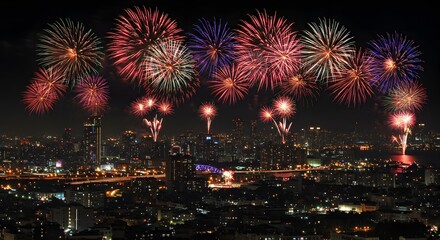 Fireworks exploding above city skyline on New Year’s Eve