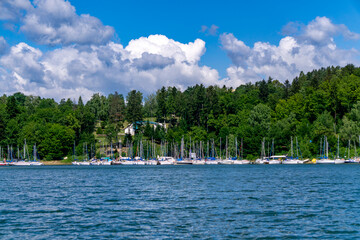 Polanczyk on Solina Lake, marina with numerous sailboats, green hills and forests of the Bieszczady Mountains.