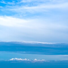 Fototapeta premium Layered clouds in a vast blue sky