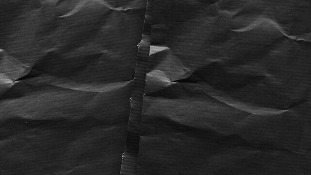 Dark Textured Paper with Jagged Seam and Creases background