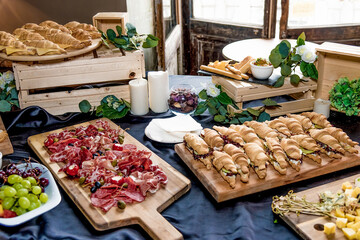 Buffet hotel restaurant, coffee break event food on wooden plates stand on table