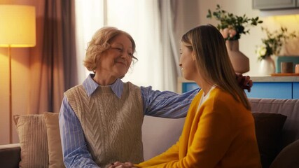 Smiling young woman hugging senior mother, showing trust, care and family love
