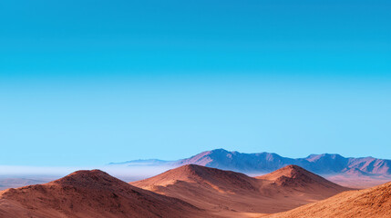 Fototapeta premium Serene desert landscape featuring rolling hills and clear blue sky, evoking sense of tranquility and vastness